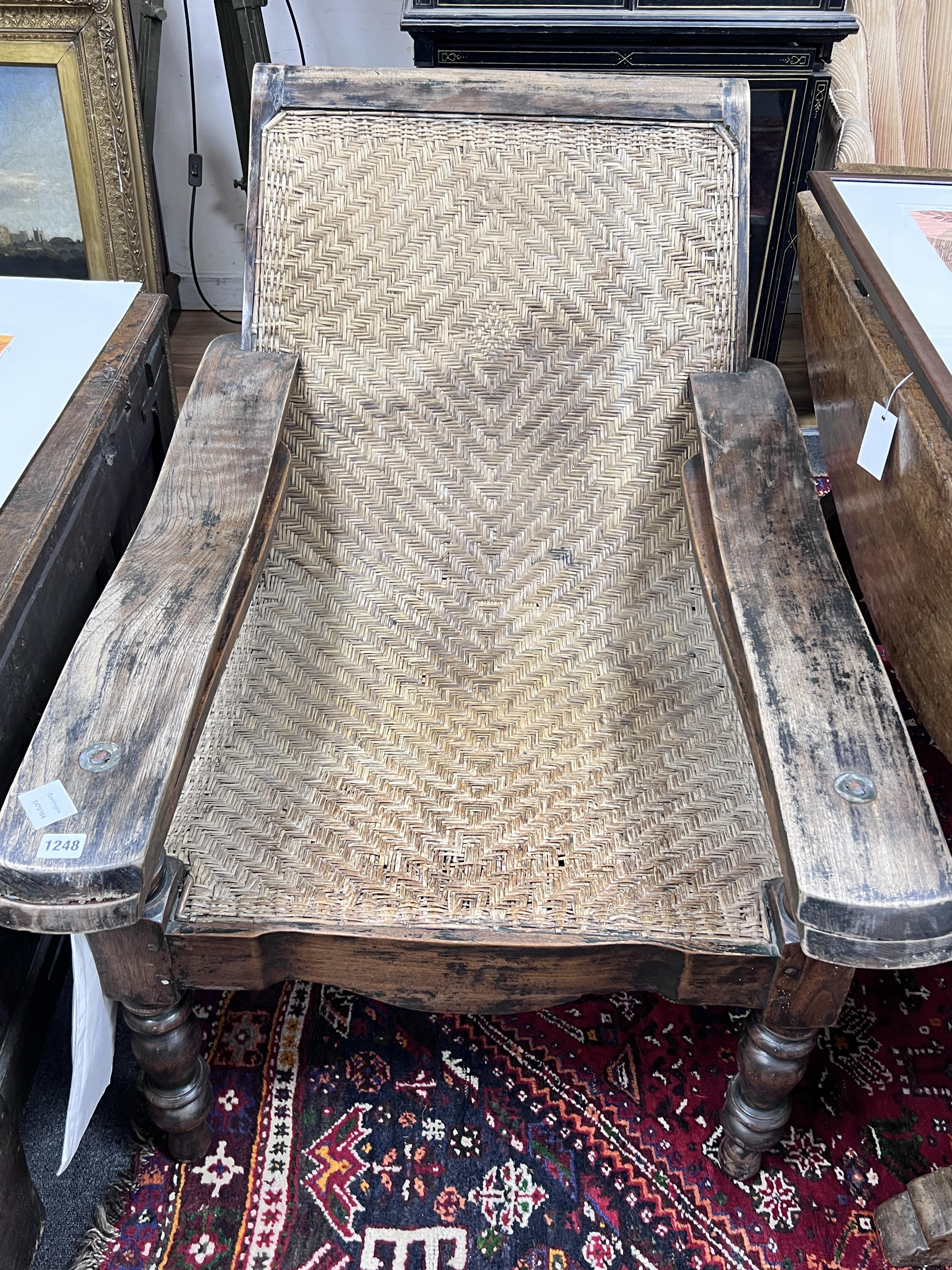 An Indian hardwood and rattan plantation chair, width 70cm, depth 110cm, height 87cm